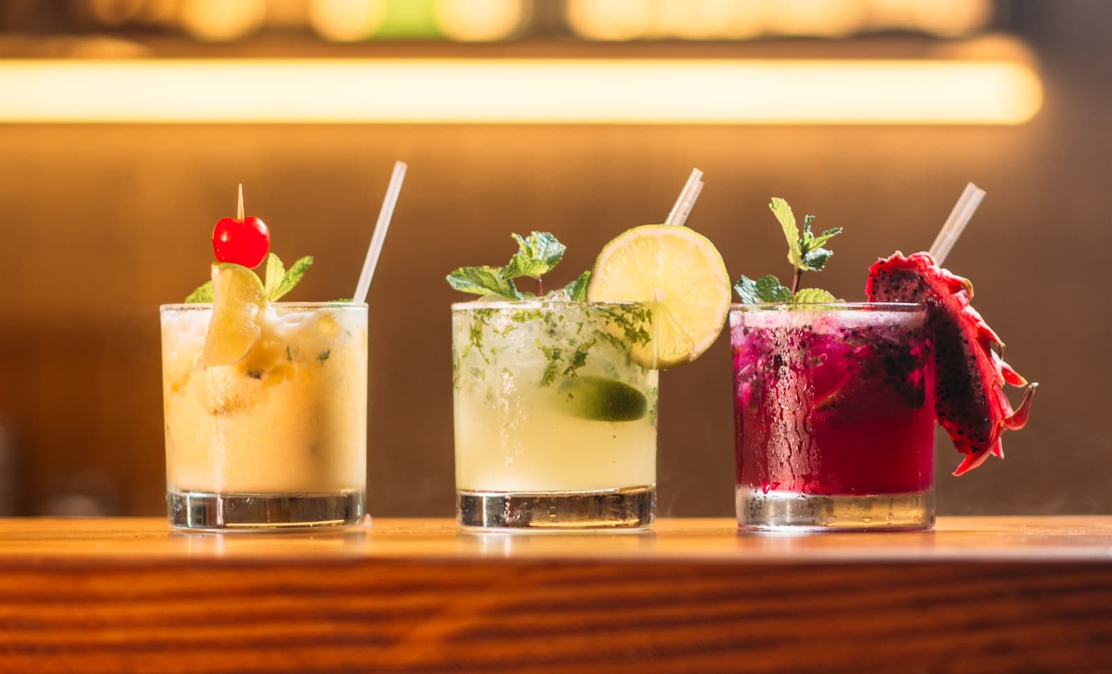 Cocktails lined up on a bar top